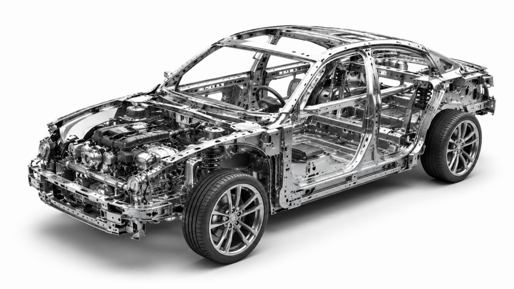 Exposed car body frame and chassis showing the internal structure, suspension, and engine components of a modern vehicle.